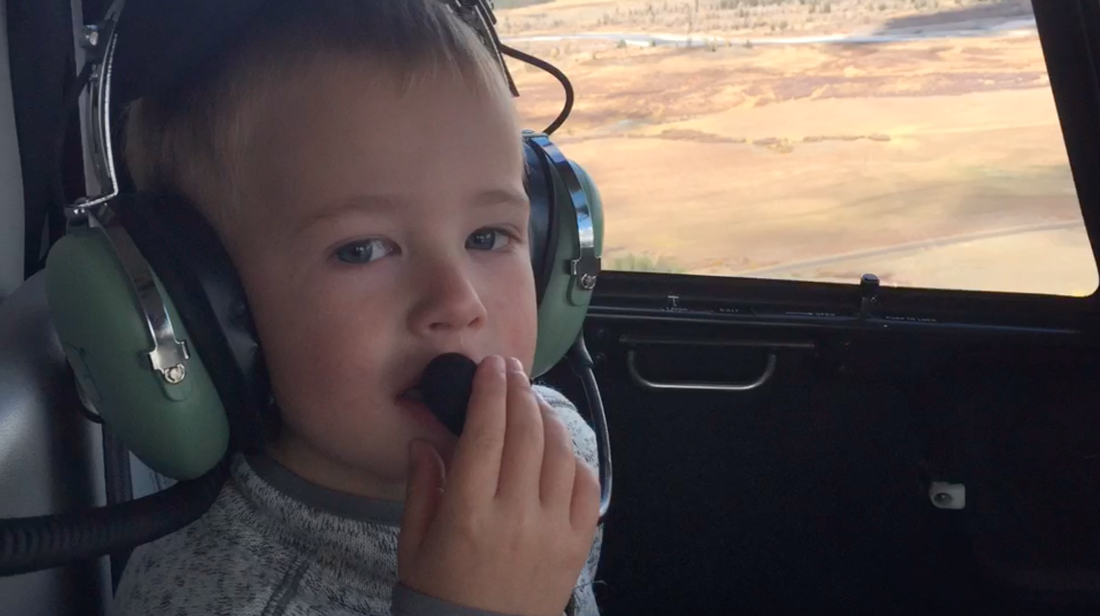 Kiddo enjoying their first helicopter flight near Jackson, WY. 