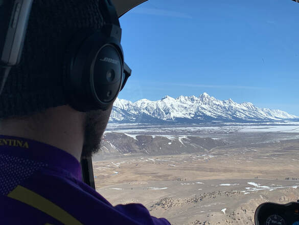 Scenic heli-tour flying towards the Jackson Hole Airport with a view of the Grand Teton. 