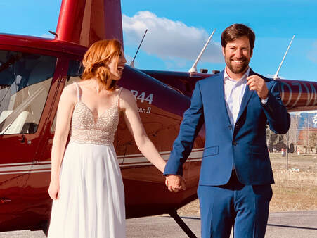 Couple on their wedding day with a rotorcraft.